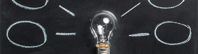 light bulb in front of chalkboard