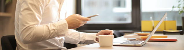 man doing research on phone at desk